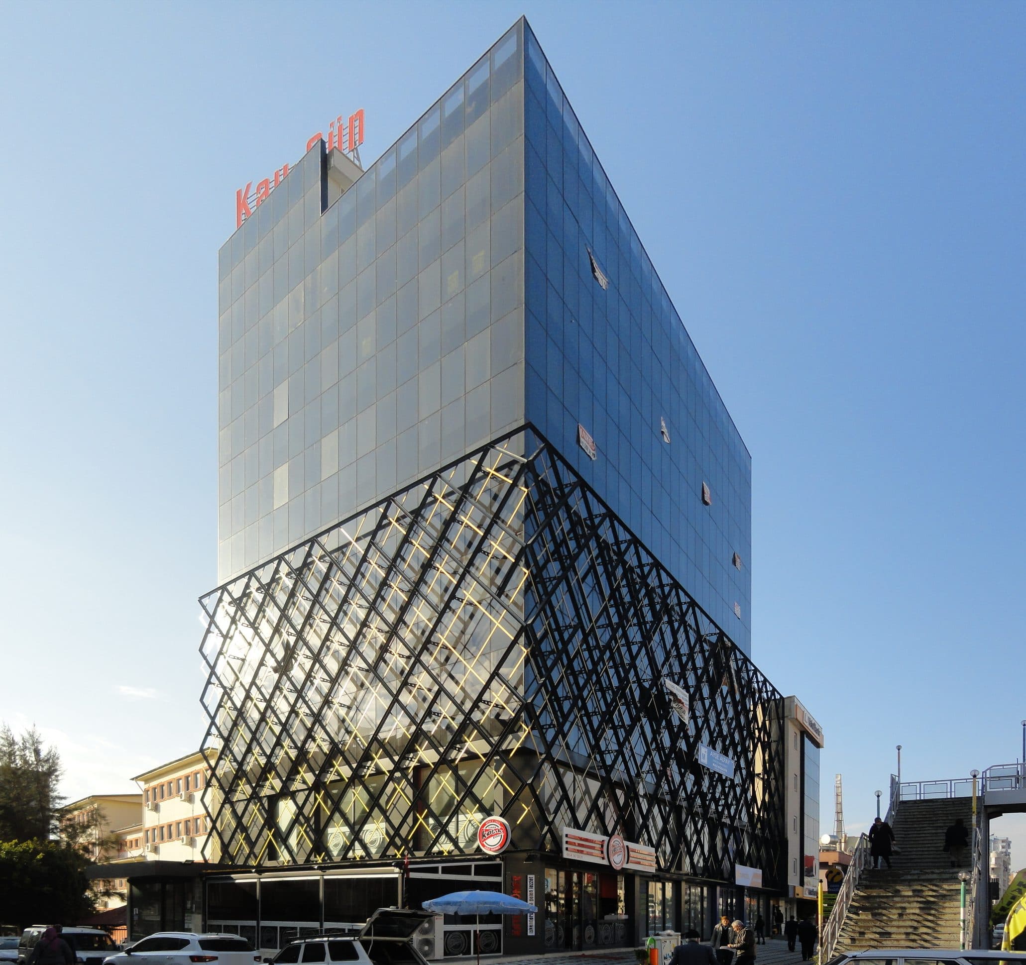 Kayıkçıoğlu Next Office köşe görünümü, güneşte altın renkli yansımalar yapan elmas desenli kafes